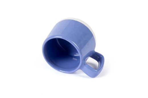 Vorster & Braye Ceramic Mug in Denim Blue Laid Down to show you inside the mug which is glazed Blue