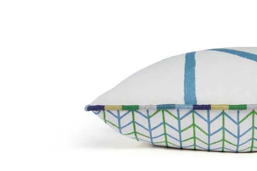 Side view of One Way / Small Way cushion showing the One Way pattern on the front and Small Way design on the back, with the crisp white linen and geometric detailing and Gala green piping.